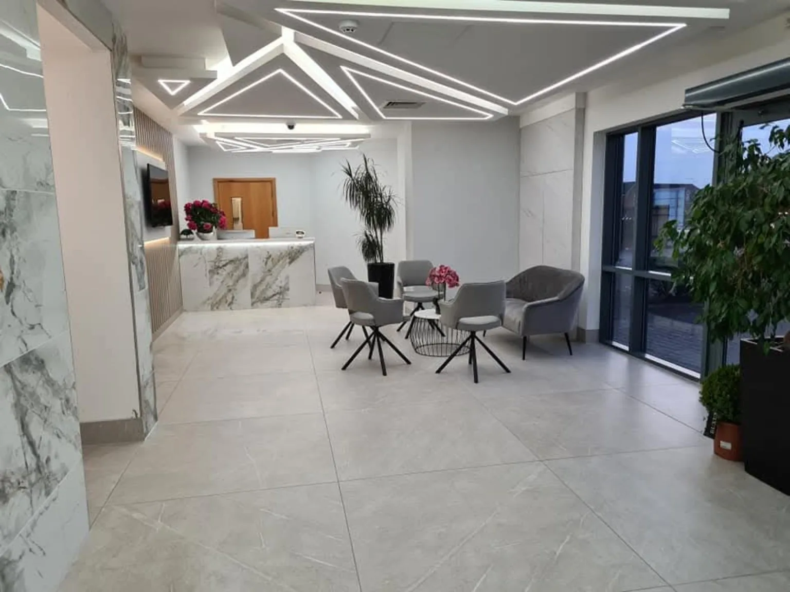 Business centre reception with clean tiled floors and upholstered seating