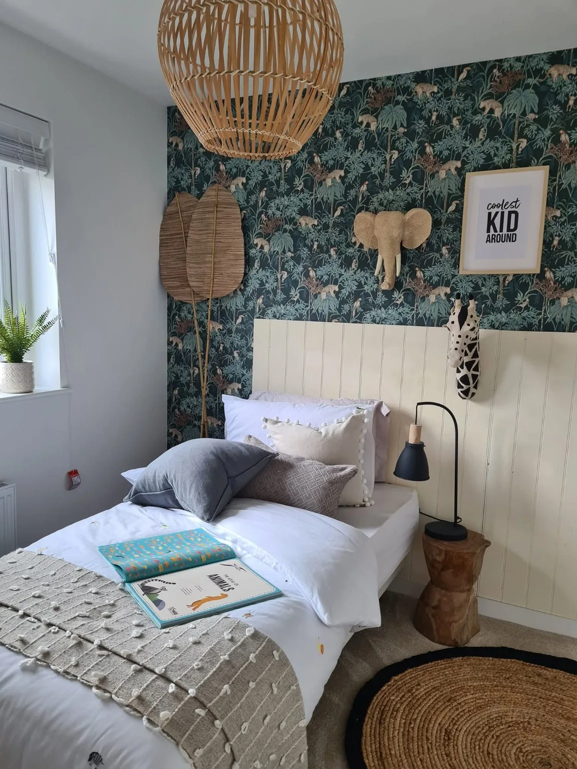 Show home bedroom with a single bed and patterned feature wall