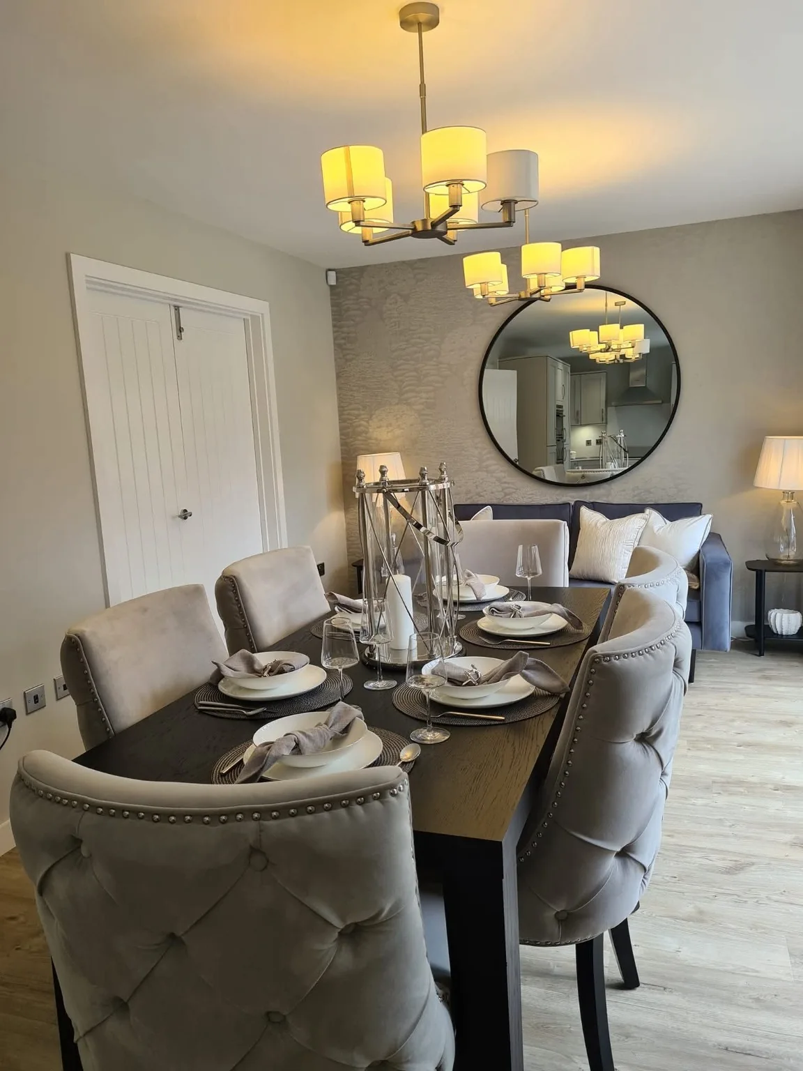 Show home dining room with a laid table and upholstered chairs