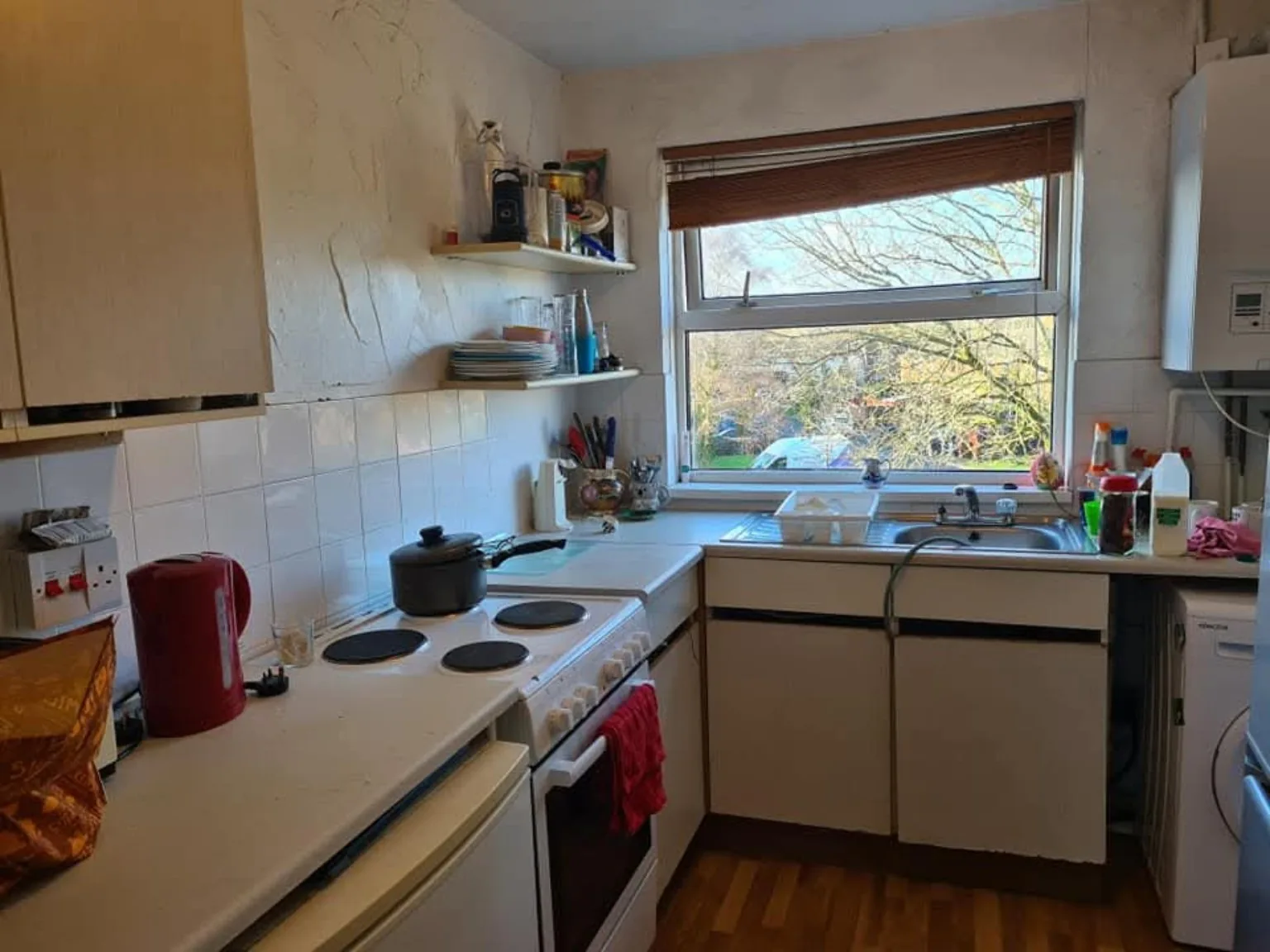 The same kitchen with work surfaces cleared and cleaned